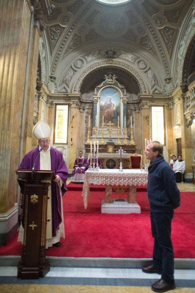 Pope Francis leads a mass while referring to a priest friend (R) from Uruguay, who surprised the the new pope by travelling from Latin America to attend his mass at Santa Anna church inside the Vatican, in a picture released by Osservatore Romano at the March 17, 2013. Pope Francis recognised the priest in the crowd when he went outside to greet them, and invited him inside to participate in the mass.