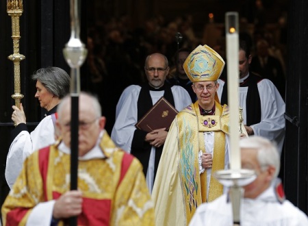 The new Archbishop of Canterbury Justin Welby leaves after his enthronement ceremony at Canterbury Cathedral, in Canterbury, southern England March 21, 2013. The new spiritual leader of the world's Anglicans was enthroned by a female cleric on Thursday, taking the helm at a time when the troubled church risks tearing itself apart over gay marriage and women bishops.