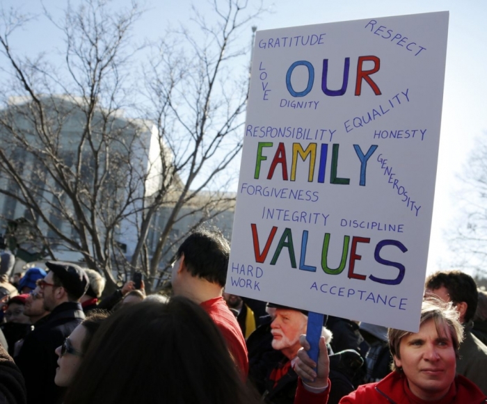 A demonstrator holds a sign outside of the U.S. Supreme Court in Washington, March 26, 2013. America's top court takes up the delicate and divisive issue of gay marriage on Tuesday when the nine Supreme Court justices consider the legality of a California ballot initiative that limits marriage to opposite-sex couples.