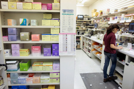 A pharmacy employee enters client information as she works to fill a prescription while working at a pharmacy in New York December 23, 2009.