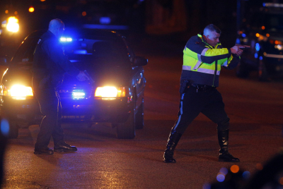 Police officers keep a man on the ground in Watertown, Massachusetts April 19, 2013 following the shooting of a police officer at the Massachusetts Institute of Technology (MIT). A police officer for the Massachusetts Institute of Technology was shot to death on Thursday night at the school's Cambridge campus, touching off a manhunt for a suspect or suspects in a community on edge just days after the Boston Marathon bombing.