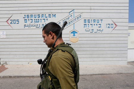 Credit : An Israeli soldier walk past a sign pointing out distances to Jerusalem and Beirut at the Rosh Hanikra border crossing with Lebanon, in northern Israel May 5, 2013.U.N. Secretary-General Ban Ki-moon on Sunday voiced alarm at reports Israel has struck targ