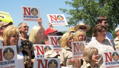 Parents, grandparents and Boy Scouts troop leaders pose for pictures during their public protest against the BSA's proposed resolution to allow for openly-gay membership into the scouts. A total of 1,400 delegates will be voting on the resolution at the national annual meeting, held this year at the Gaylord Texan in Grapevine, Texas. May 22, 2013.