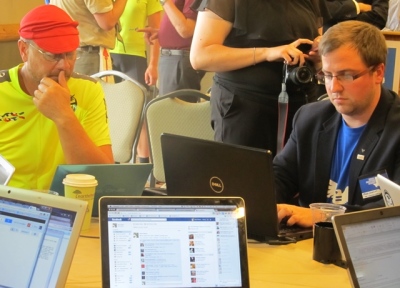 Dave McGrath (L) an Eagle Scout and LGBT advocate, sits beside Scouts for Equality's communications team as they respond to supporters' comments and await the results of the national council's vote tally before the BSA's official announcement. Scouts for Equality and the Inclusive Scouting Network were joined by GLADD to promote LGBT issues in the BSA. Grapevine, Texas, May 23, 2013.