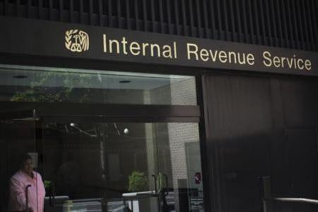 A woman walks out of the Internal Revenue Service building in New York on May 13, 2013.