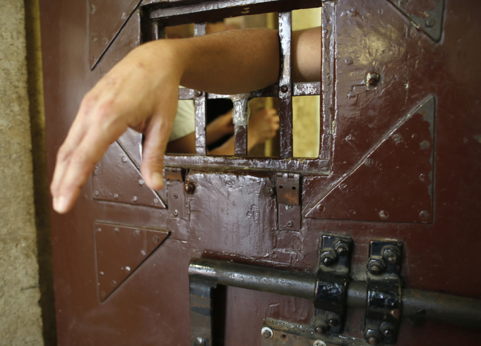 A prisoner puts his arm through the door of his cell in this 2013 file photo.