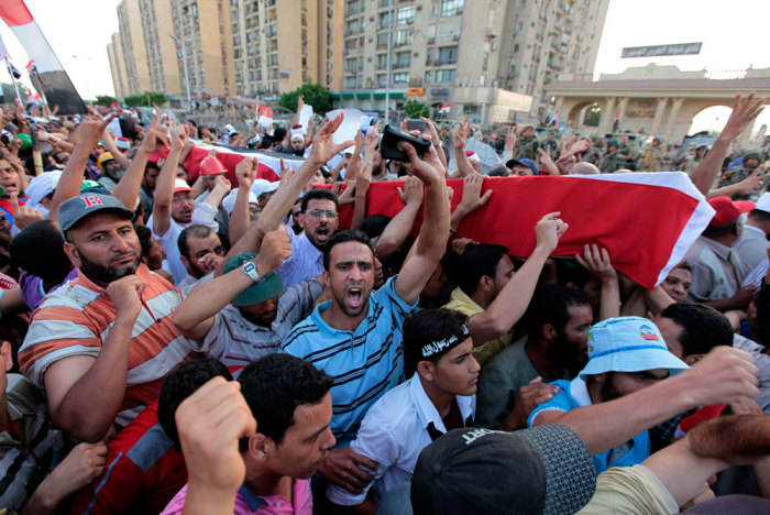 Supporters of deposed Egyptian President Mohamed Mursi carry mock coffins during a symbolic funeral for the four men killed during clashes with police outside the Republican Guard headquarters a day earlier, in Cairo July 6, 2013. Egypt counted its dead on Saturday after Islamists enraged by the overthrow of Mursi took to the streets in an explosion of violence against what they denounced as a military coup.