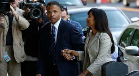 Jesse Jackson Jr. (center) and his wife, Sandi (right), arrive in court for their sentencing hearing in Washington, Aug. 14.