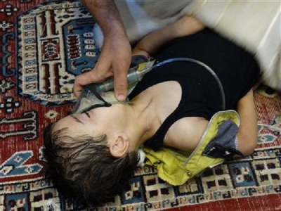 A boy, affected by what activists say is nerve gas, breathes through an oxygen mask in the Damascus suburb of Saqba, August 21, 2013.