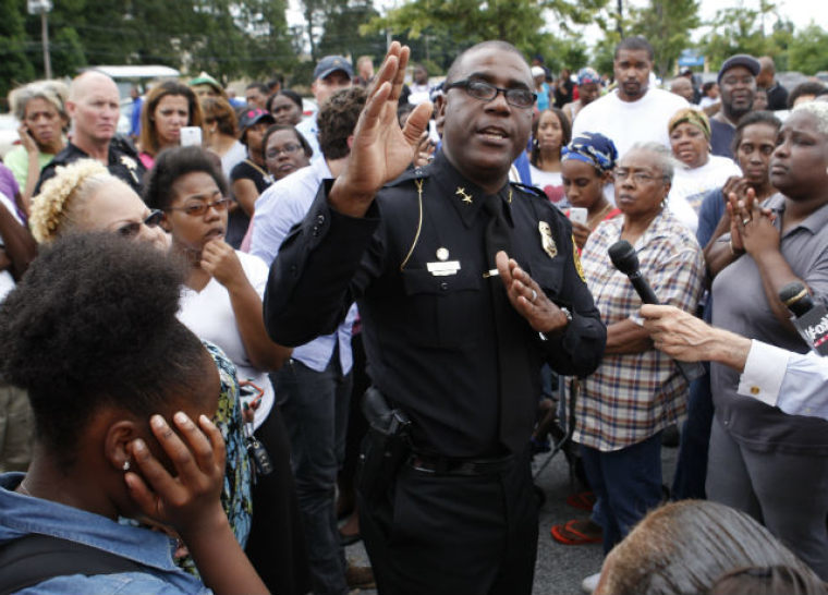 Dekalb County Assistant Police Chief Dale Holmes talks to a crowd of parents at a local Walmart following an shooting incident at McNair Discovery Learning Academy in Decatur, Ga., on Aug. 20, 2013.