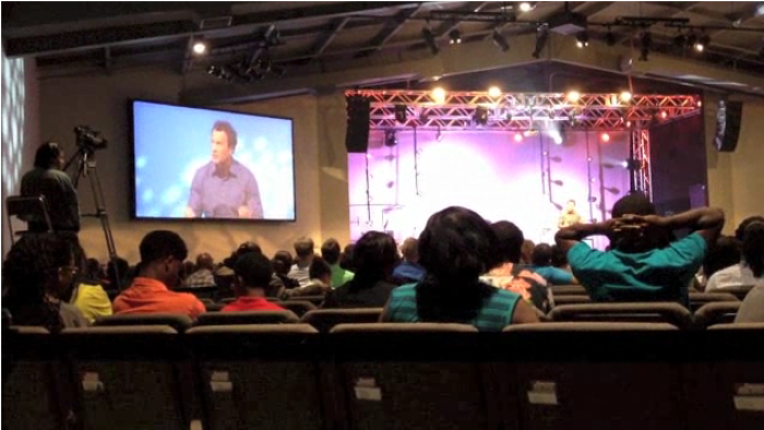 Congregants listen to an apology from Troy Maxwell, pastor of Freedom House Church in Charlotte, N.C. on Sunday.