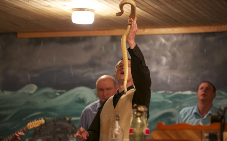 Pastor Andrew Hamblin holds up an albino snake.