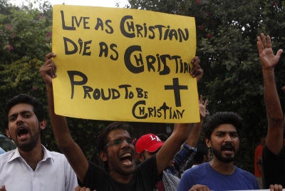 A member of the Pakistani Christian community holds a placard as he shouts slogans during a protest rally to condemn Sunday's suicide attack in Peshawar on a church, with others in Lahore September 23.