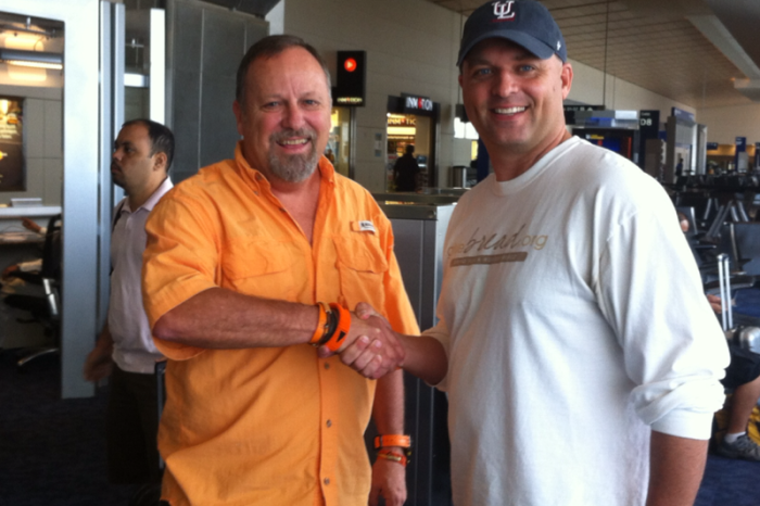 Milton Jones, president of the Christian Relief Fund, celebrates a merger by shaking hands with Bobby Moore, former president of Bread for a Hungry World, new vice president of global operation for the umbrella organization, also called the Christian Relief Fund.