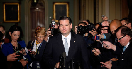 Reporters gather around U.S. Senator Ted Cruz (R-TX), who announces he will not filibuster, as he talks to reporters after a Republican Senate caucus meeting at the U.S. Capitol in Washington October 16, 2013. The U.S. Senate announced a last-minute deal on Wednesday to avert a historic lapse in the government's borrowing ability and a potentially damaging debt default, and to reopen the government after a two-week shutdown.