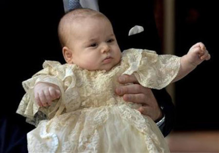 Britain's Prince William carries his son Prince George as they arrive for his son's christening at St James's Palace in London October 23, 2013.