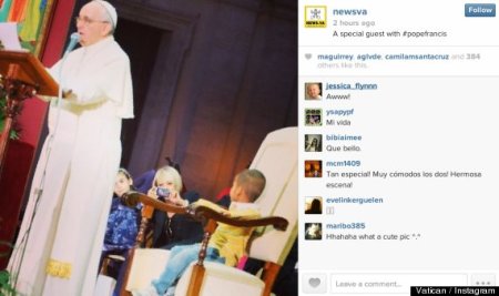 A young boy wearing a yellow shirt takes a seat in Pope Francis' chair as the pontiff addresses a crowd full of families at the Vatican earlier this week.