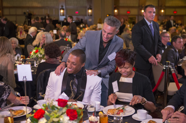 Lecrae Moore, who is featured in 'The Cross,' with his wife, Darragh Moore, greeted by Billy Graham's grandson Tullian Tchividjian.