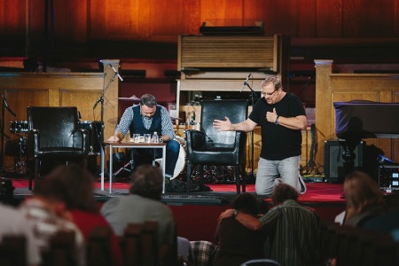 Pastor Rick Warren (R) prays with Pastor Mark Driscoll on stage during Resurgence conference at Mars Hill Downtown Church in Seattle, Nov. 6, 2013.