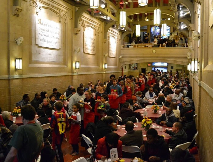 Bowery Mission volunteers help serve meals on Thanksgiving 2012.