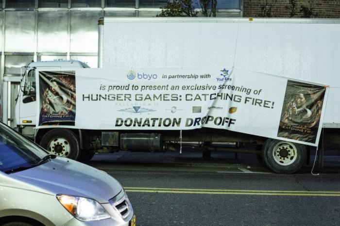 Last week, BBYO, a Jewish teen organization, organized prescreenings of the new film 'The Hunger Games: Catching Fire,' but with a twist – they teamed up with local food banks and asked for food donations. Across the country, Jewish teens in this effort donated over 17,000 pounds of food. This poster advertises the screening in Detroit, Michigan, which attracted 595 teens and collected 1,100 pounds of food.