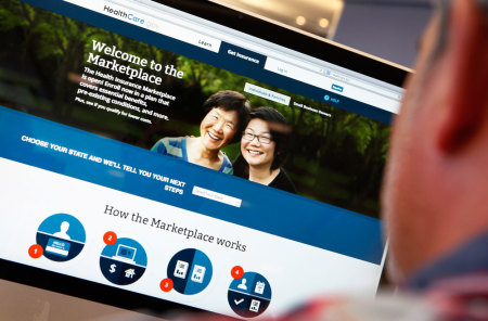 A man looks over the Affordable Care Act (commonly known as Obamacare) signup page on the HealthCare.gov website in New York in this October 2, 2013 photo illustration. The federal government's portal logged over 2.8 million visitors by afternoon October 2, largely in an attempt to sign up for Obamacare.