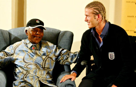 Former South African President Nelson Mandela chats with England soccer captain David Beckham at Nelson Mandela's Foundation office in Johannesburg May 21,2003.