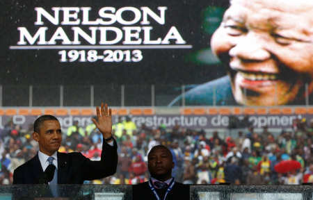 U.S. President Barack Obama addresses the crowd during a memorial service for Nelson Mandela at FNB Stadium in Johannesburg, South Africa December 10, 2013. World leaders, from U.S. President Barack Obama to Cuba's Raul Castro, will pay homage to Mandela at the memorial that will recall his gift for bringing enemies together across political and racial divides.