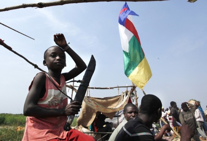 A child holds a machete in Bangui. Religious leaders sought reconciliation between Muslims and Christians in Central African Republic in mid-December during a lull in violence.