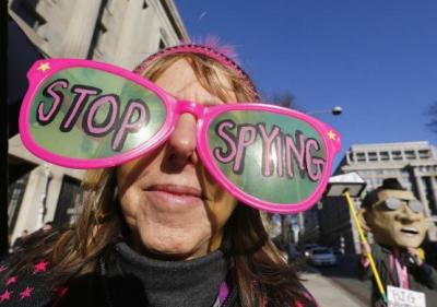 The founder of the protest group Code Pink Medea Benjamin wears large sunglasses as she protests against U.S. President Barack Obama and the NSA before his arrival at the Department of Justice in Washington, January 17, 2014.