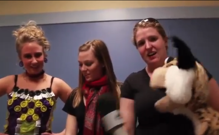 A student wearing condoms attached to lingerie is being interviewed by a puppet at Montana State University's third annual 'Latex and Lace Condom Fashion Show' in 2012.