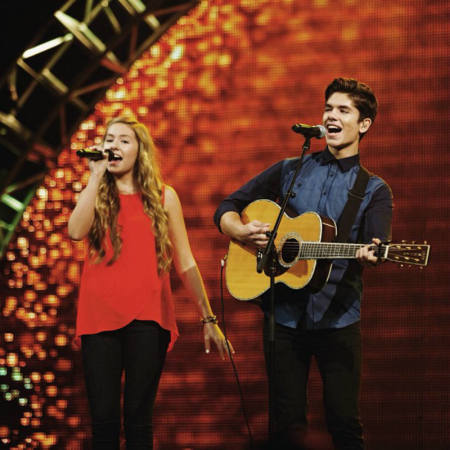 Alexandra and Jonathan Osteen, children of Joel and Victoria Osteen, perform on stage.