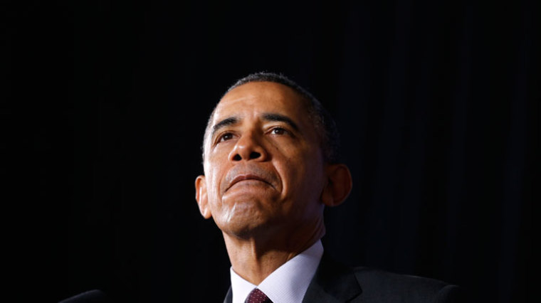 U.S. President Barack Obama pauses while speaking during a visit to Buck Lodge Middle School in Adelphi, Maryland February 4, 2014.