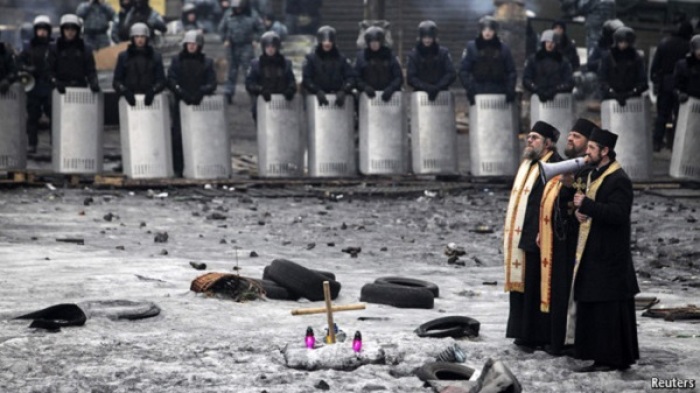 Ukraine priests speaking to the crowd at the backdrop of armed guards in this February 2014 photo.