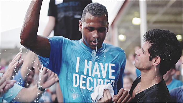 Pastor Steven Furtick (r) of Elevation Church in Charlotte, N.C., baptizes a new convert.