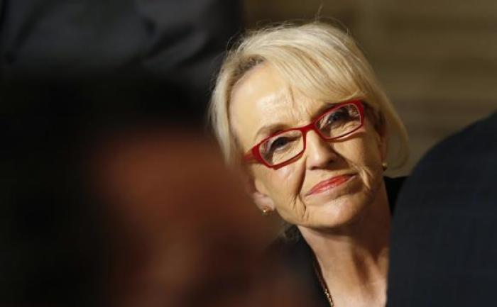 Arizona Governor Jan Brewer looks up as U.S. President Barack Obama addresses the National Governors Association in the State Dining Room of the White House in Washington February 24, 2014.