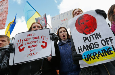 People protesting against Russian troops in Ukraine gather outside an European Union emergency foreign ministers meeting in Brussels March 3, 2014. EU foreign ministers will push on Monday for high-level mediation to resolve the crisis over Russia's invasion of Crimea, while threatening the possibility of sanctions if Russia does not back down.