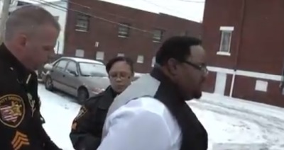 The Rev. Melford Elliott, pastor at Greater Bethel Baptist Church, is 'fake arrested' as part of the 'Defending the Faith' public outreach effort in Akron, Ohio.