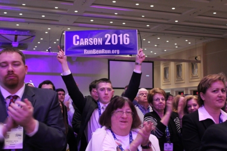 A CPAC attendee holds up a sign reading 'Carson 2016,' at the Conservative Political Action Conference in National Harbor, Md., March 8, 2014.