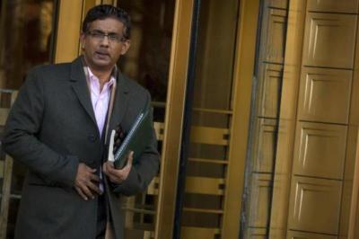 Conservative commentator and best-selling author, Dinesh D'Souza exits the Manhattan Federal Courthouse in New York, Jan. 24, 2014.