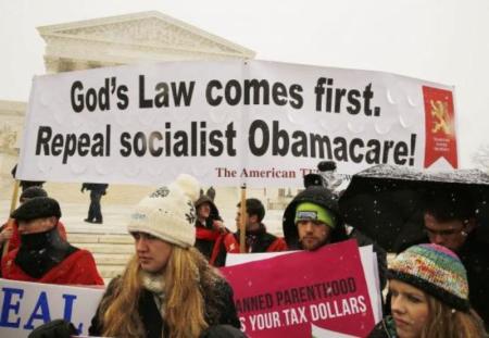 Protesters rally at the steps of the U.S. Supreme Court as arguments began on March 25, 2014, to challenge the Affordable Care Act's requirement that employers provide coverage for contraception and abortion-inducing drugs.