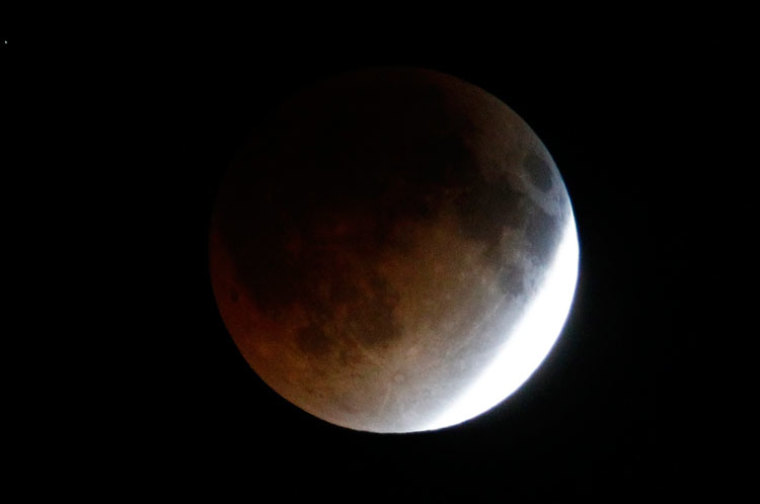 A shadow falls on the moon as it undergoes a total lunar eclipse as seen from Mexico City April 15, 2014.