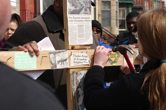 Jersey City churches hold a Stations of the Cross for sites of violent crime in the city. At each station, a worshiper hammered a nail into the cross.