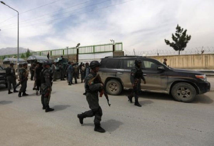 Afghan policemen secure the area outside Cure Hospital after three foreigners were killed in Kabul April 24, 2014.