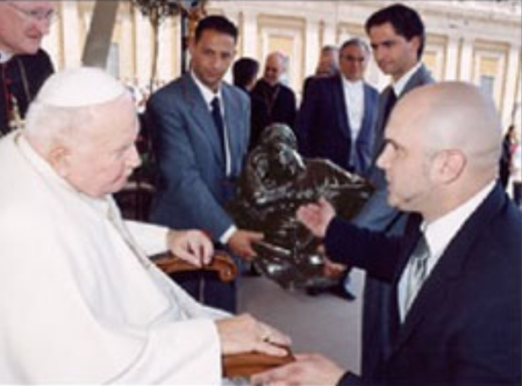 Canadian artist Tim Schmalz presents 'A Quiet Moment' model size bronze to Pope John Paul II at the Vatican on June 30, 2004.