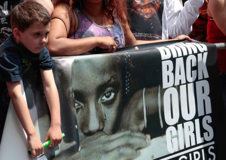 A boy takes part in a prayer vigil for abducted Nigerian schoolgirls in front of the Consulate General of Nigeria in Manhattan, New York May 10, 2014. Boko Haram kidnapped more than 250 girls from a secondary school in Chibok in remote northeastern Nigeria on April 14 and has threatened to sell them into slavery.