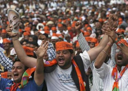 Supporters of Hindu nationalist Narendra Modi, prime ministerial candidate for India's main opposition Bharatiya Janata Party and Gujarat's chief minister, cheer as they listen to Modi during a rally in Hiranagar, India, March 26, 2014.