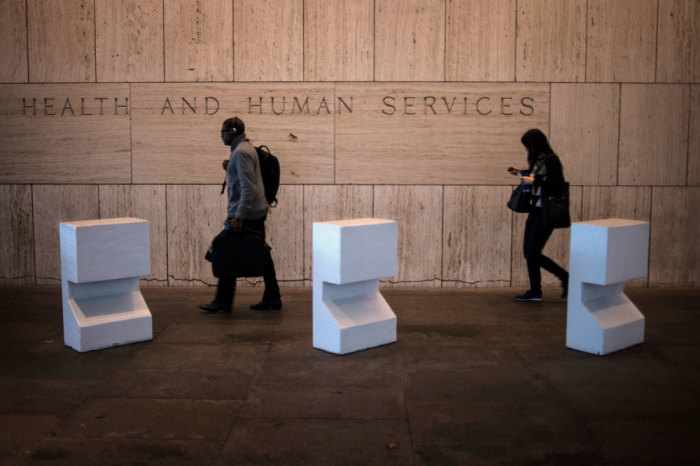 Workers arrive at the Department of Health and Human Services Tuesday morning after the federal government shutdown in Washington October 1, 2013. 