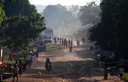 People walk along a main street in the Central African Republic capital of Bangui where at least 30 people were killed in an attack by Muslim extremists on a Christian church at a refugee camp on May 28, 2014.