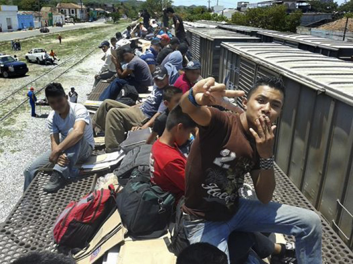 Jorge, 22, riding on 'the beast' to complete an unauthorized trip across the U.S. border from Mexico.